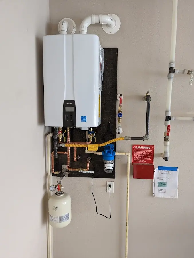 Professional plumber installing copper piping in a Longmont home